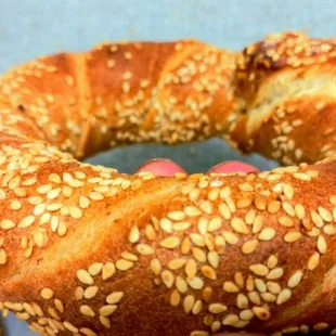 Simit is known as Turkish Bagel, a delicious Turkish street bread that is tangled sesame-bathed and ring-shaped like a bagel.
