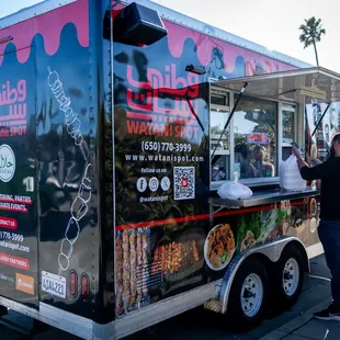 people ordering food from a food truck