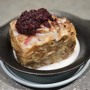 Croissant bread pudding with blackberry compot and sugar glaze. Great portion, and deliciously moist.