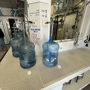 two large jugs on a counter