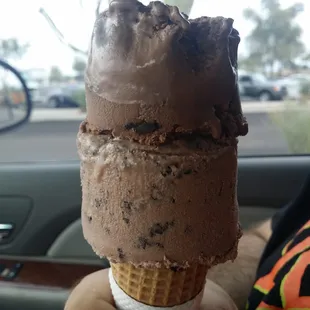 a person holding an ice cream cone