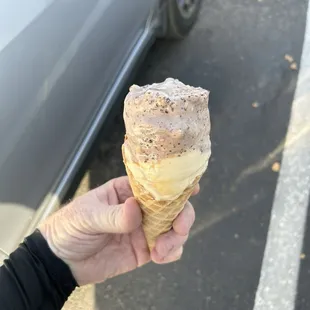 Chocolate malted crunch and salted caramel ice cream in a waffle cone.