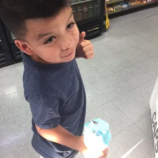 a boy giving a thumbs up