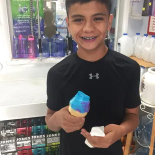 a boy holding an ice cream cone