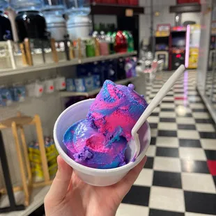 a person holding a bowl of ice cream