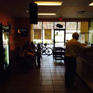 people sitting at tables in a restaurant