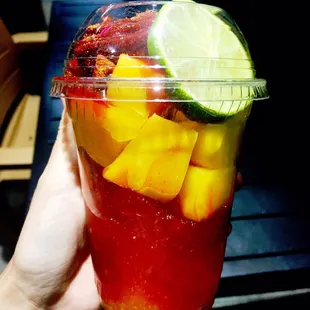 Mangonada (shaved ice, mango syrup, fresh mangoes, chamoy, tamarind candy, fresh lime)