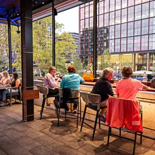 several people sitting at a bar