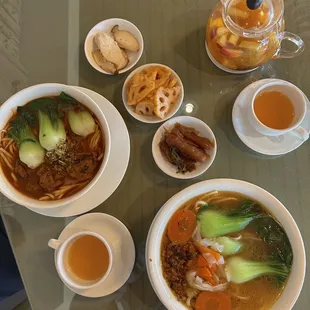 a bowl of soup, a bowl of soup, and a cup of tea