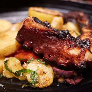 Wild Spanish octopus (charcoal grilled with fingerling potato, nicoise olives, roasted tomato, lemon and olive oil)