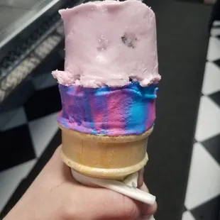 a hand holding an ice cream cone