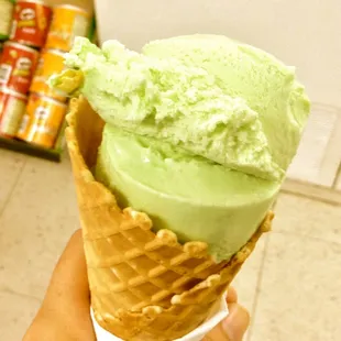 a hand holding an ice cream cone