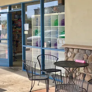 a table and chairs outside a store