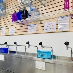 Water station with hand towels to clean water bottles for customers.