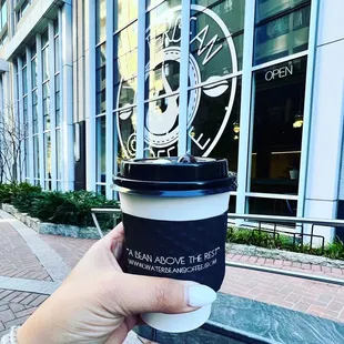 a person holding a cup of coffee