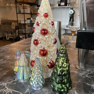 three christmas trees on a counter