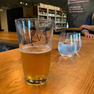 a glass of beer and a half full glass of water
