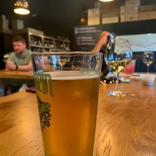 a glass of beer on a bar