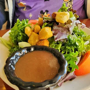 a plate of salad and dipping sauce