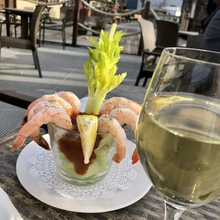 a plate of food and a glass of wine