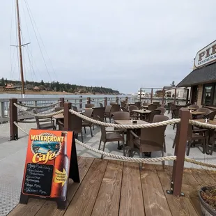 a view of a dock with tables and chairs