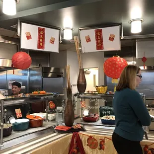 a woman standing in front of the counter