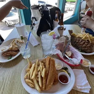 a woman sitting at a table with a plate of food