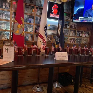 a long table with glasses of beer on it