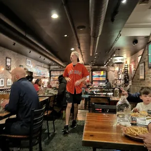 a group of people sitting at tables in a restaurant