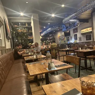 people sitting at tables in a restaurant