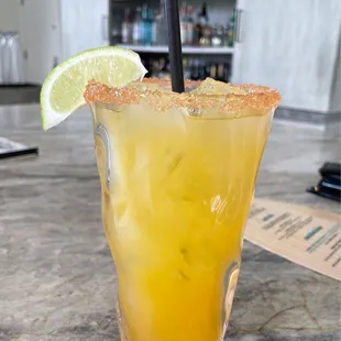 a margarita with a lime wedge