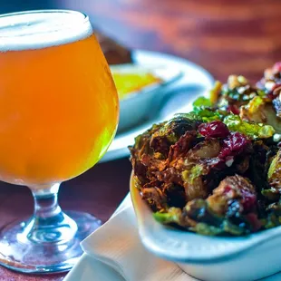 a glass of beer and a plate of food