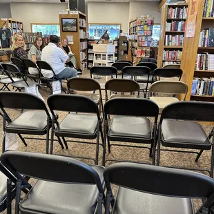 people sitting in chairs in a library