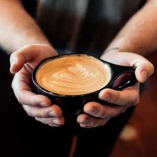 a person holding a cup of coffee