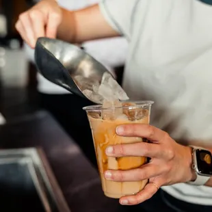 a person pouring a drink