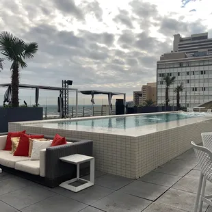 a rooftop pool and lounge area