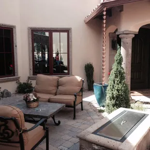 a patio with a fire pit