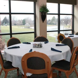 a dining room with a view of a golf course