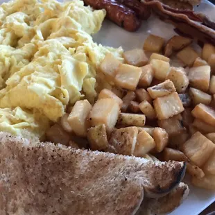 Maumee Bay Breakfast Three eggs, hash browns, bacon, sausage, toast, and a short stack