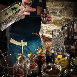 a bartender pouring a drink at a bar