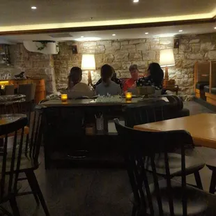 a group of people sitting at tables in a restaurant