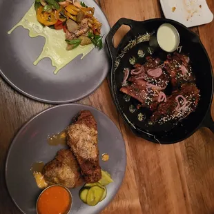 three plates of food on a wooden table