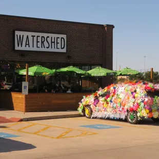 a car decorated with flowers and umbrellas