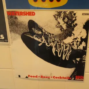 a poster on the wall of a bathroom