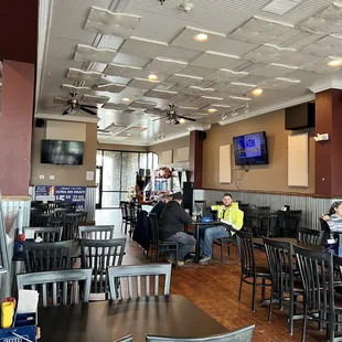 people sitting at tables in a restaurant