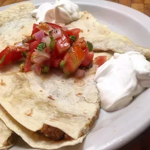 Mmm, rabbit quesadilla! Ground rabbit + chayote squash + onions + Oaxaca cheese + pico de gallo + sour cream.