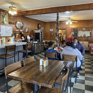 people sitting at tables in a restaurant