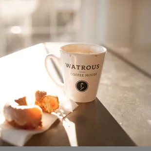 a cup of coffee and a croissant