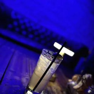 a glass of alcohol on a wooden table