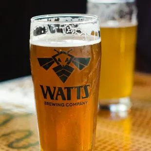 two glasses of beer on a table